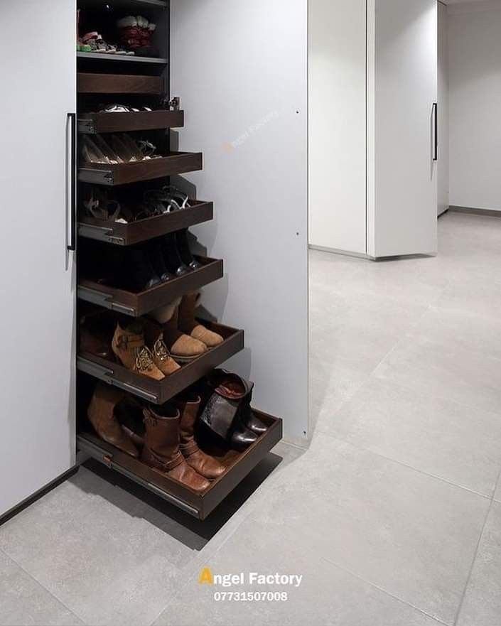 an open closet with shoes on the bottom shelf and inside shelves that are full of shoes