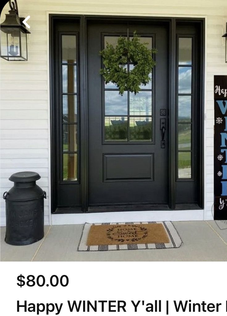 a black front door with the words happy winter y'all winter sale on it