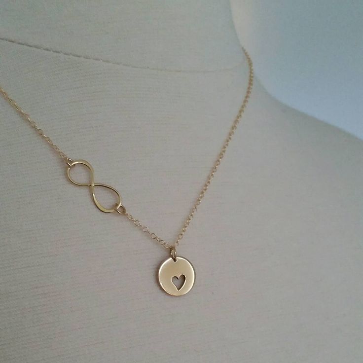 Our updated version of mother daughter necklaces now with infinity link. Two separate necklaces featuring golden bronze cut out heart disc for mother and tiny heart charm for daughter. 14k gold filled fine cable chain. small heart charm necklace-16'' Cutout heart charm necklace-18'' *Please let me know if you need diff. length. I do not charge extra up to 20'' cutout heart disc-13mm heart charm-7mm Infinity Jewellery, Mother Daughter Necklaces, Godmother Jewelry, Mom Daughter Jewelry, Mother Daughter Jewelry, Heart Disc, Mother Of The Bride Gift, Mother Daughter Necklace, Mother Daughter Gifts