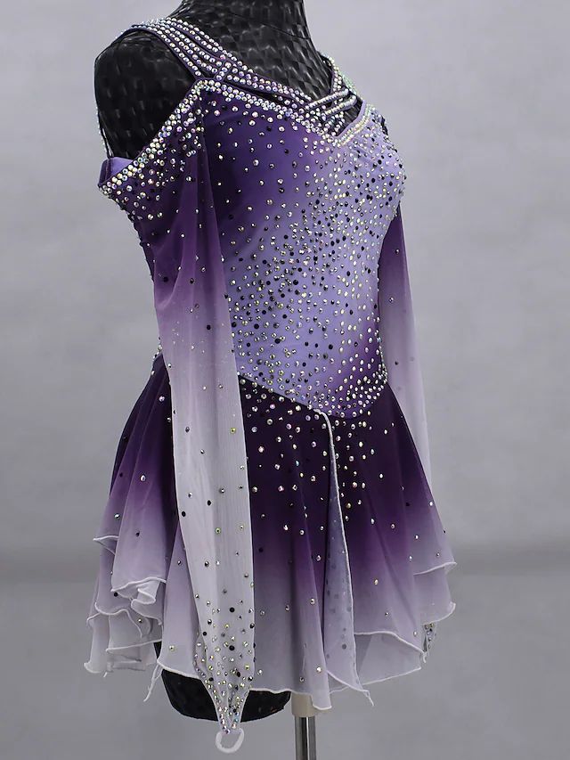 a purple and white figure skating dress on display