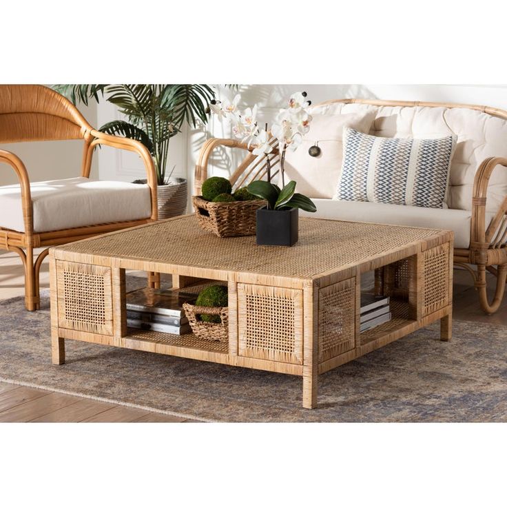 a living room with wicker furniture and plants on the coffee table in front of it