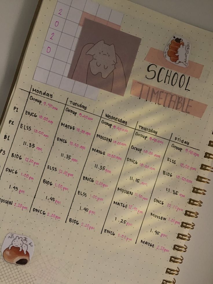 a school timetable with stickers on it and an elephant drawn on the page next to it