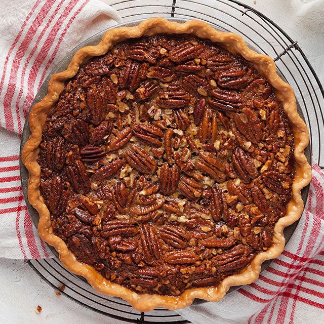 a pecan pie sitting on top of a wire rack