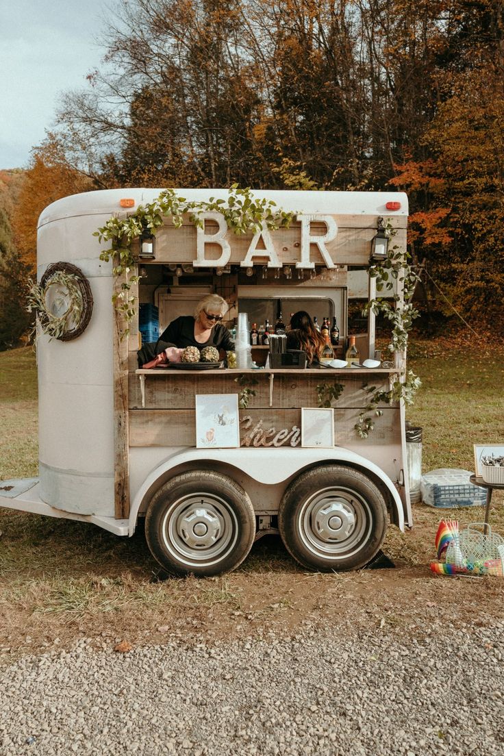 an old food truck is parked on the side of the road with people in it