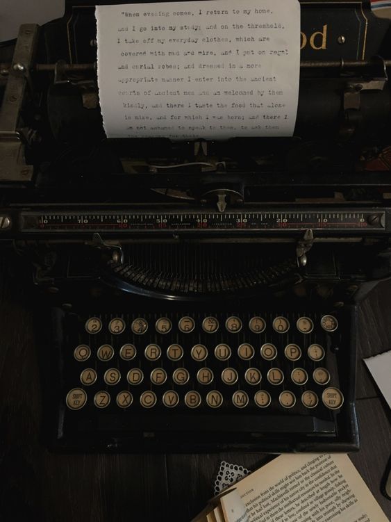 an old fashioned typewriter sitting on top of a desk