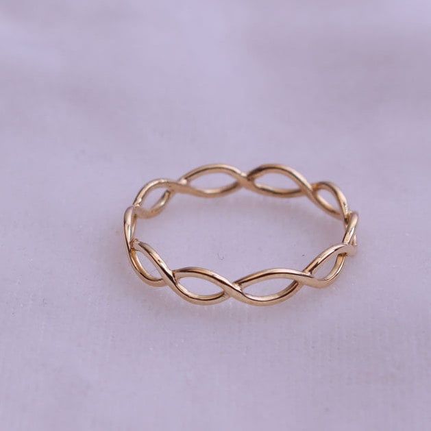 a gold ring sitting on top of a white sheet