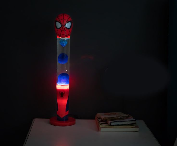 a spider man lamp sitting on top of a table