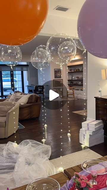 a living room filled with furniture and balloons