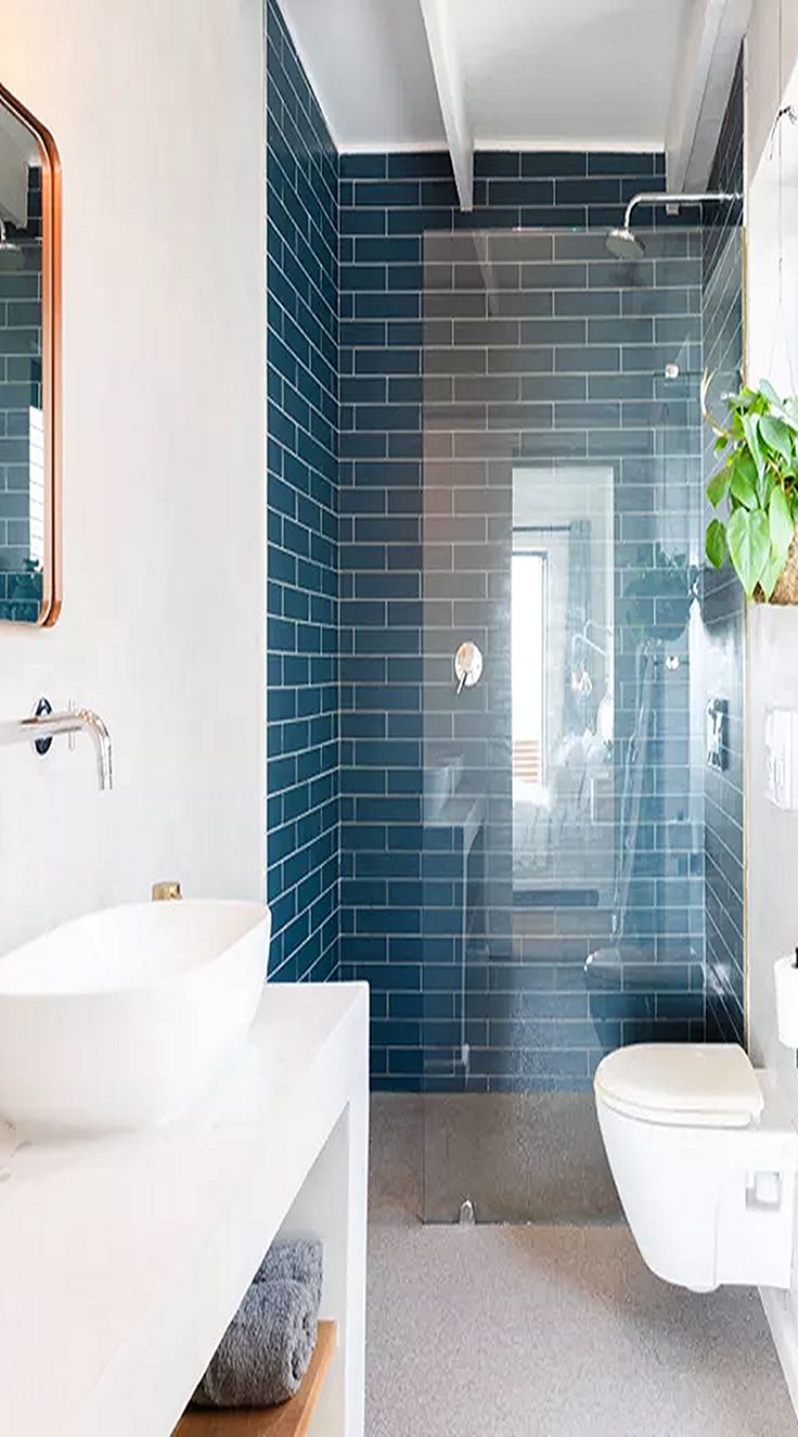 a bathroom with a toilet, sink and shower in it's own area is shown