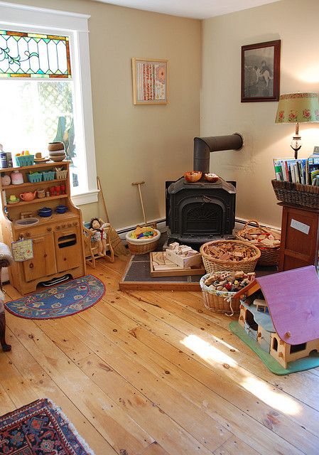 a living room filled with furniture and a fire place next to a wooden stove top oven