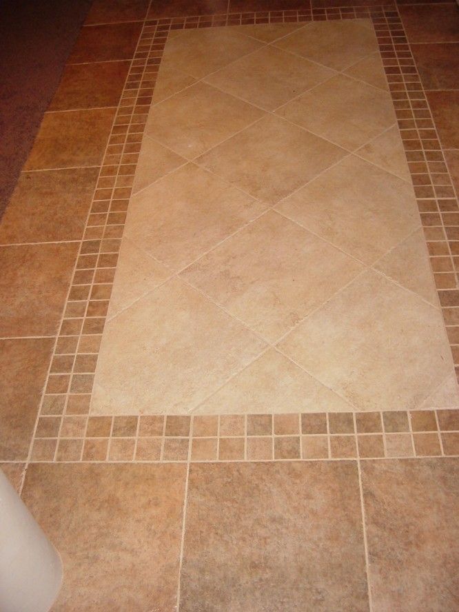 the bathroom floor is clean and ready to be used as a bathtub or shower