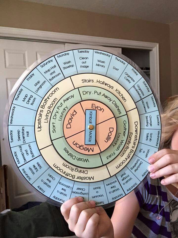 a young boy holding up a wheel of fortune board game in front of his face