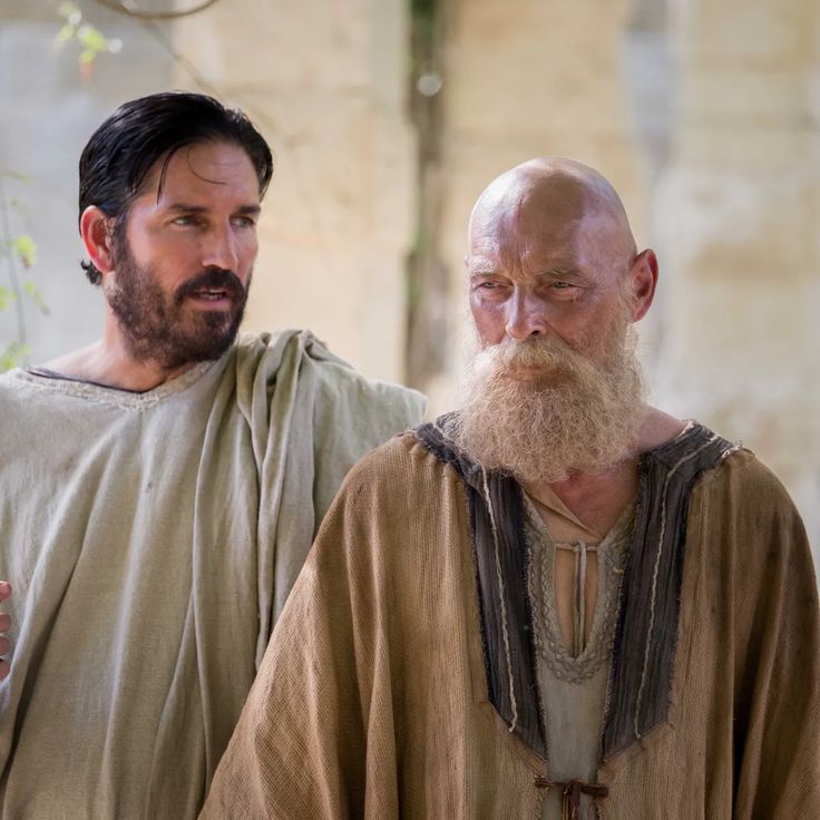 two men with beards standing next to each other