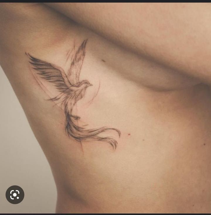 a woman's stomach with a bird tattoo on it