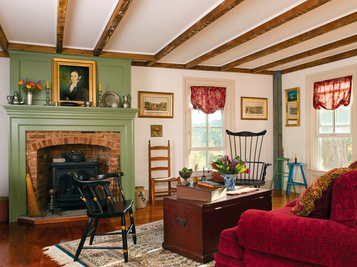 a living room filled with furniture and a fire place in front of a painting on the wall