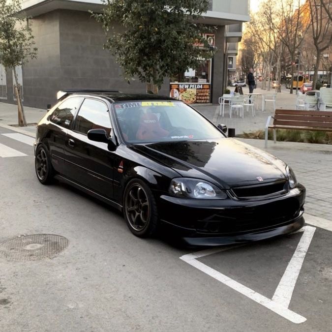 a black car is parked on the street