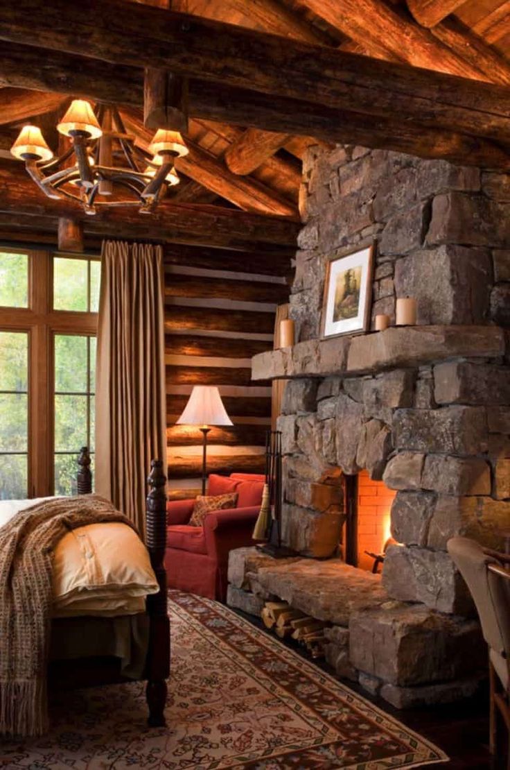 a stone fireplace in a rustic cabin bedroom