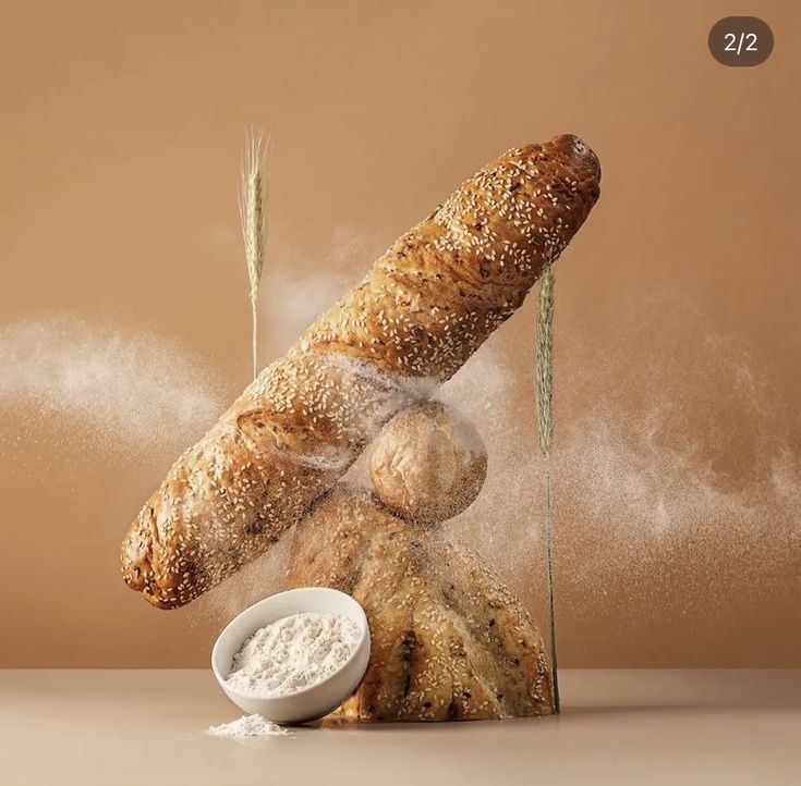 a large piece of bread with powdered sugar on it next to a white bowl