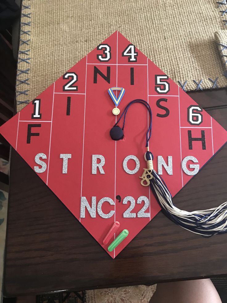 a red graduation cap with numbers on it and a tassel hanging from the top