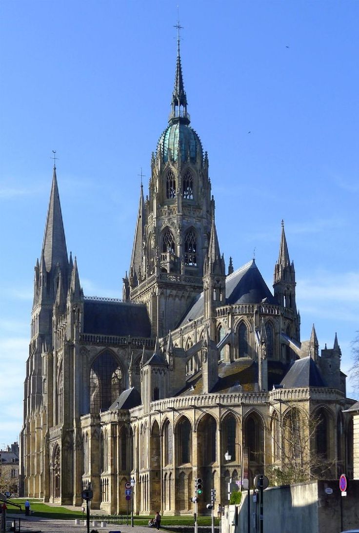 an old building with many spires on the front and side of it is shown