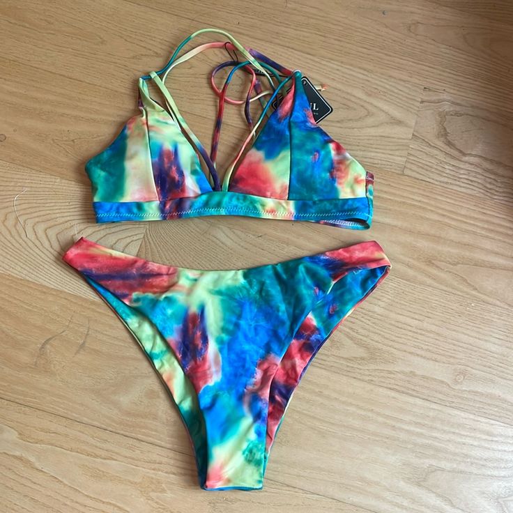 This Listing Is For A Brand New With Tags Zaful Brand, Rainbow Tie-Dye Bikini In A Women’s Size 8. If You Have No Experience With This Brand, Just Know The Bottoms Are Always Always So Nicely Made. They Are Always Fully Lined With The Same Fabric That Is On The Outside. So You Never Get That Little White Lining Flipping Over Or Anything. They Are Finished Very Nicely. Please Let Me Know If You Have Any Questions. Thank You So Much For Shopping My Closet Feel Free To Bundle And Save Offers Are Always Welcome. Please Note The Top Has Nice Detailing In The Front And The Back The Leasing In The Back Is Really Pretty. Tie Dye Swimwear For Summer Pool Days, Tie Dye Triangle Top Swimwear, Tie Dye Swimwear For Pool In Summer, Summer Tie Dye Swimwear For Pool, Summer Tie Dye Swimwear For Swimming, Fitted Tie Dye Swimwear For The Beach, Summer Tie-dye Swimwear For Pool, Tie-dye Swimwear For Summer Pool, Tie-dye Swimwear For Beach Season