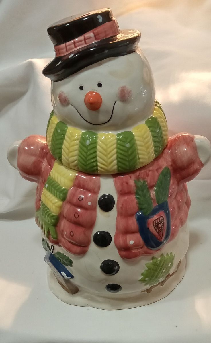 a ceramic snowman with a hat and scarf