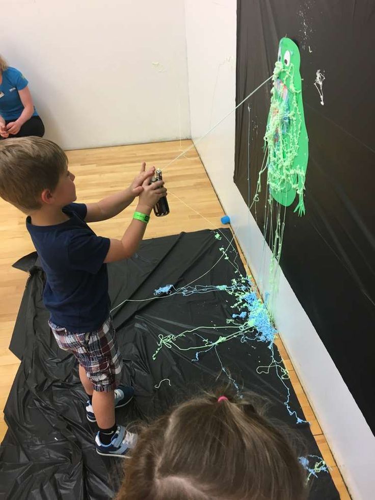 a young boy is playing with an art project