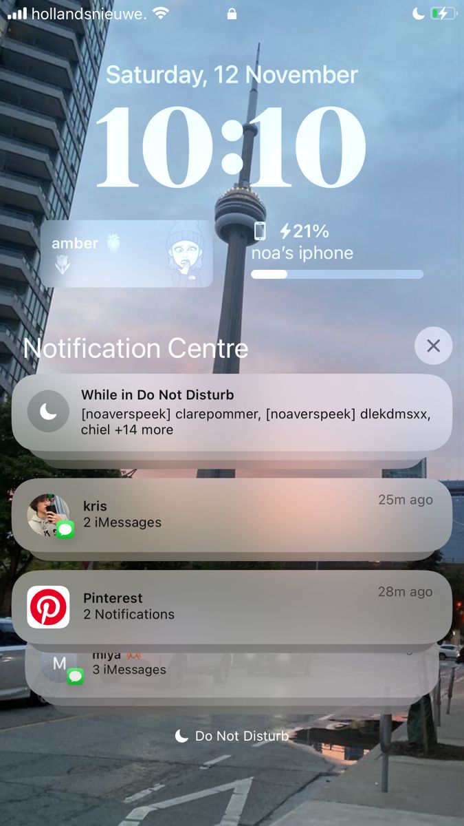 an iphone screen showing the time and location of someone's cell phone in front of a tall building