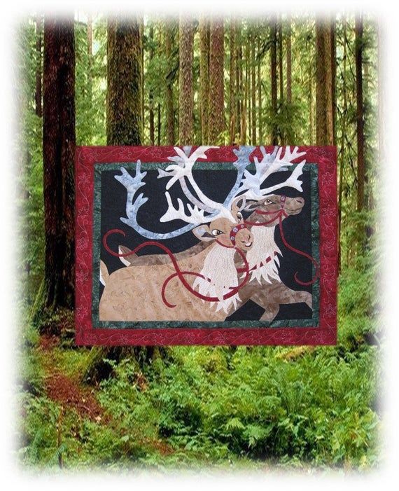 a quilted moose with antlers on it in the woods