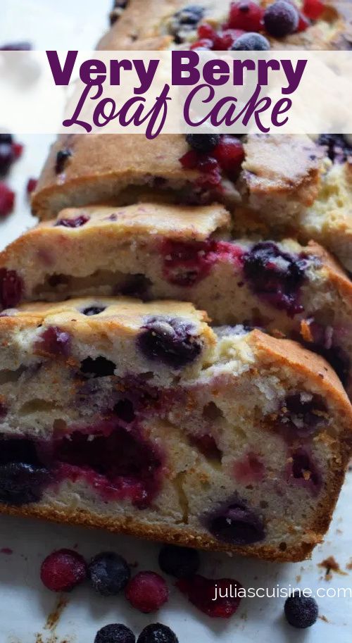 very berry loaf cake with blueberries and raspberries on top, cut into slices