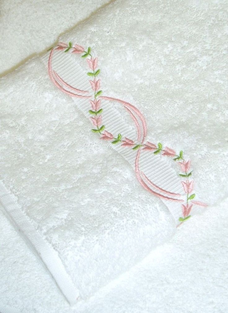 a white towel with pink and green trim on it