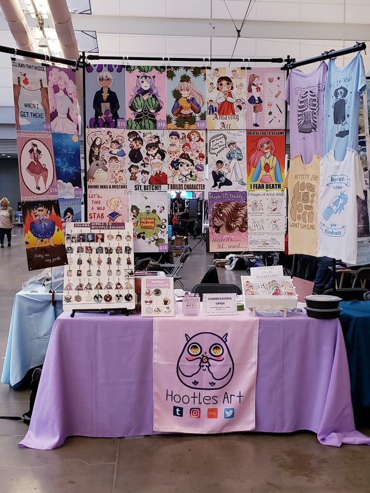 a purple table topped with lots of posters