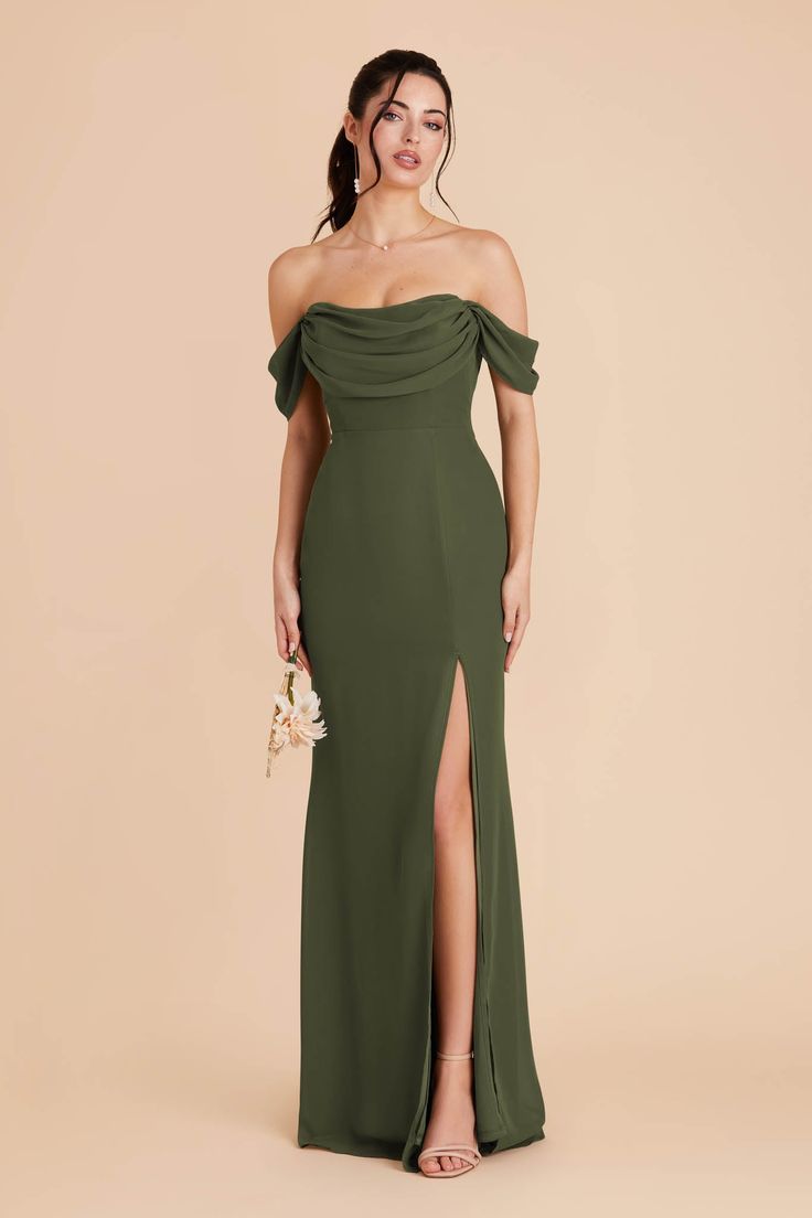 a woman in a long green dress with an off the shoulder top and side slit