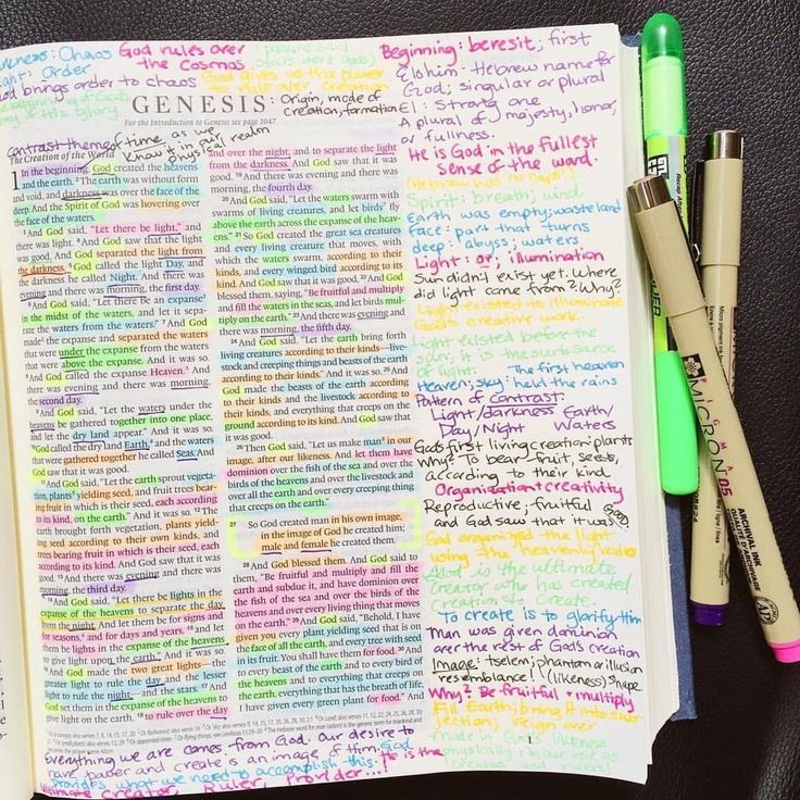 an open notebook with writing on it and three pens next to it, all in different colors