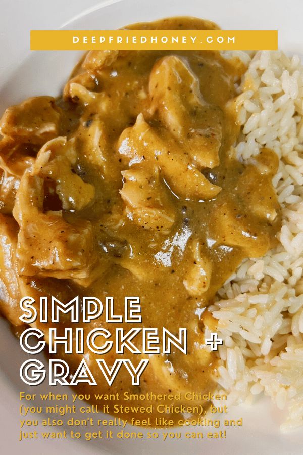 a white plate topped with chicken and gravy covered in gravy next to rice