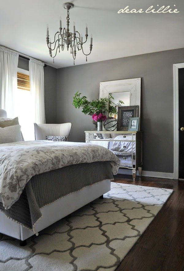 a bedroom with gray walls and white furniture