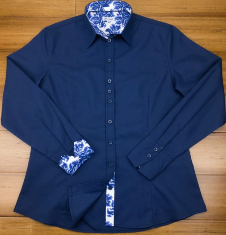 Chic and smart too! This stunning navy-blue cotton twill shirt is contrasted with a tremendous delft blue floral design to make this a great everyday wardrobe staple. Darted front and back provide a more tailored and figure-hugging look. DETAILS Material (100% micro twill cotton) Turn back Cuffs Contrasting color and cuffs Anti-gape Button placket Care (Machine wash at 30°) Country of Origin (Thailand) Classic Indigo Shirt For Work, Fitted Blue Dress Shirt For Office, Navy Fitted Tops With Spread Collar, Navy Fitted Top With Spread Collar, Fitted Navy Shirt For Spring, Navy Fitted Shirt For Spring, Blue Fitted Dress Shirt With Fold Down Collar, Fitted Blue Dress Shirt With Fold Down Collar, Fitted Blue Shirt For Semi-formal Occasions