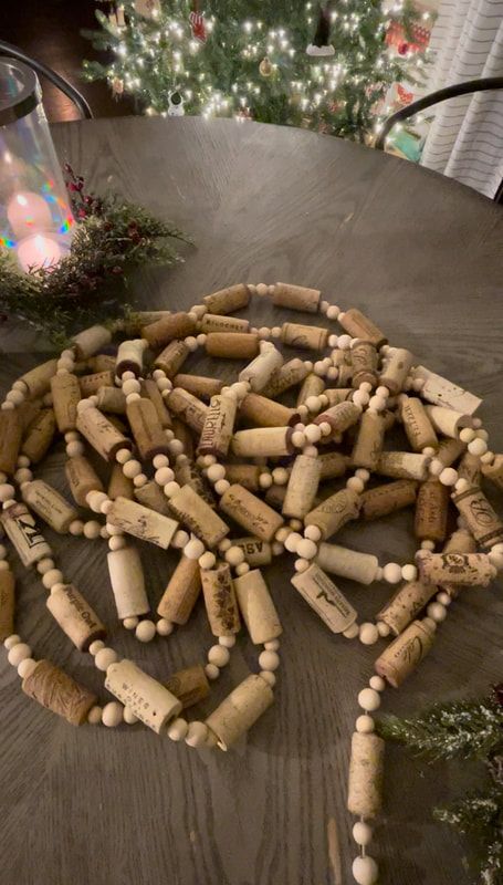 a bunch of wine corks laid out on a table next to a christmas tree