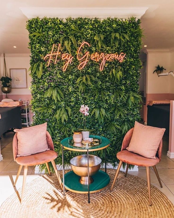 two chairs and a table in front of a green wall with the words happy congrat written on it