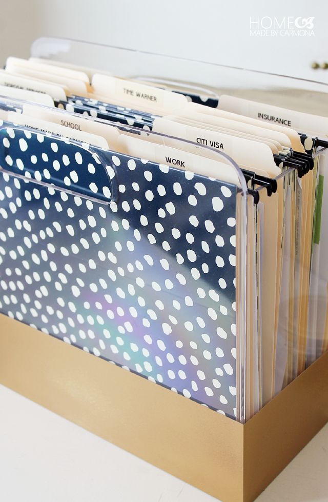 file folders are stacked on top of each other in a metal holder with white polka dots