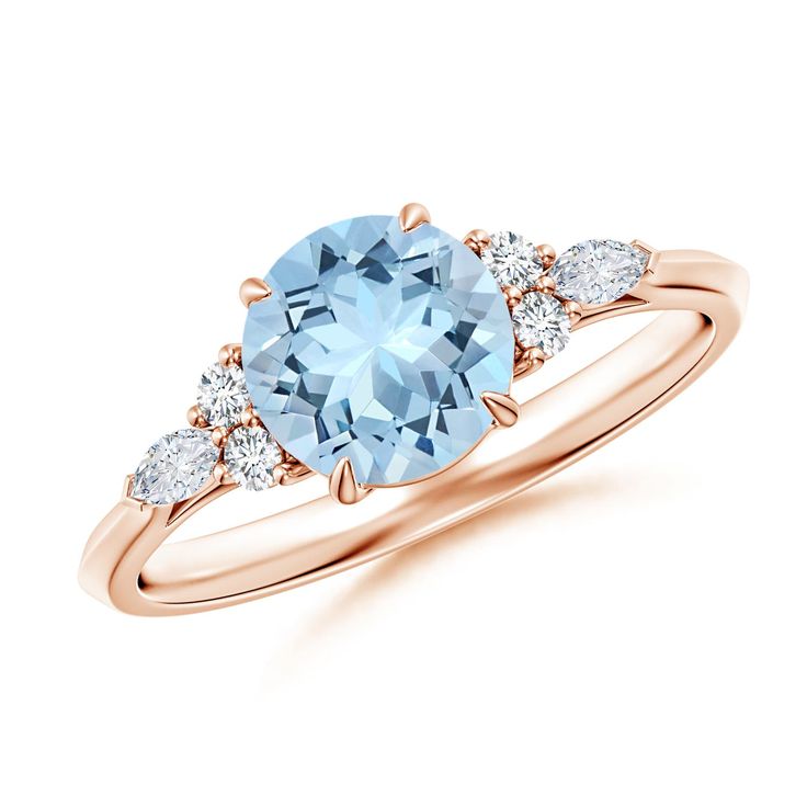 an oval blue topaz ring with three diamonds on the band and side stones in rose gold