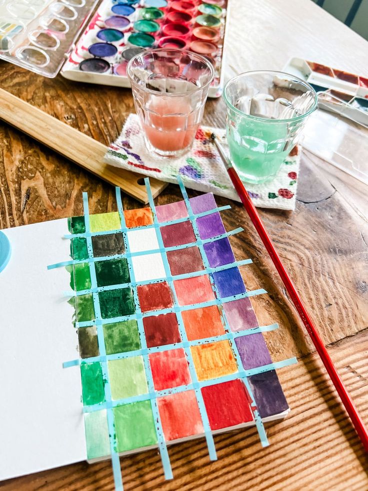 a wooden table topped with lots of different colored paints