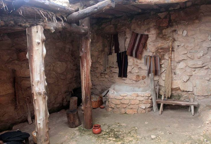 an old stone building with clothes hanging from the roof