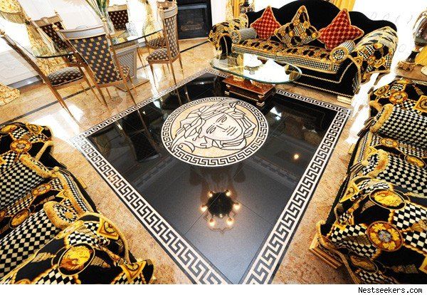 an elaborately decorated living room with black and gold furniture