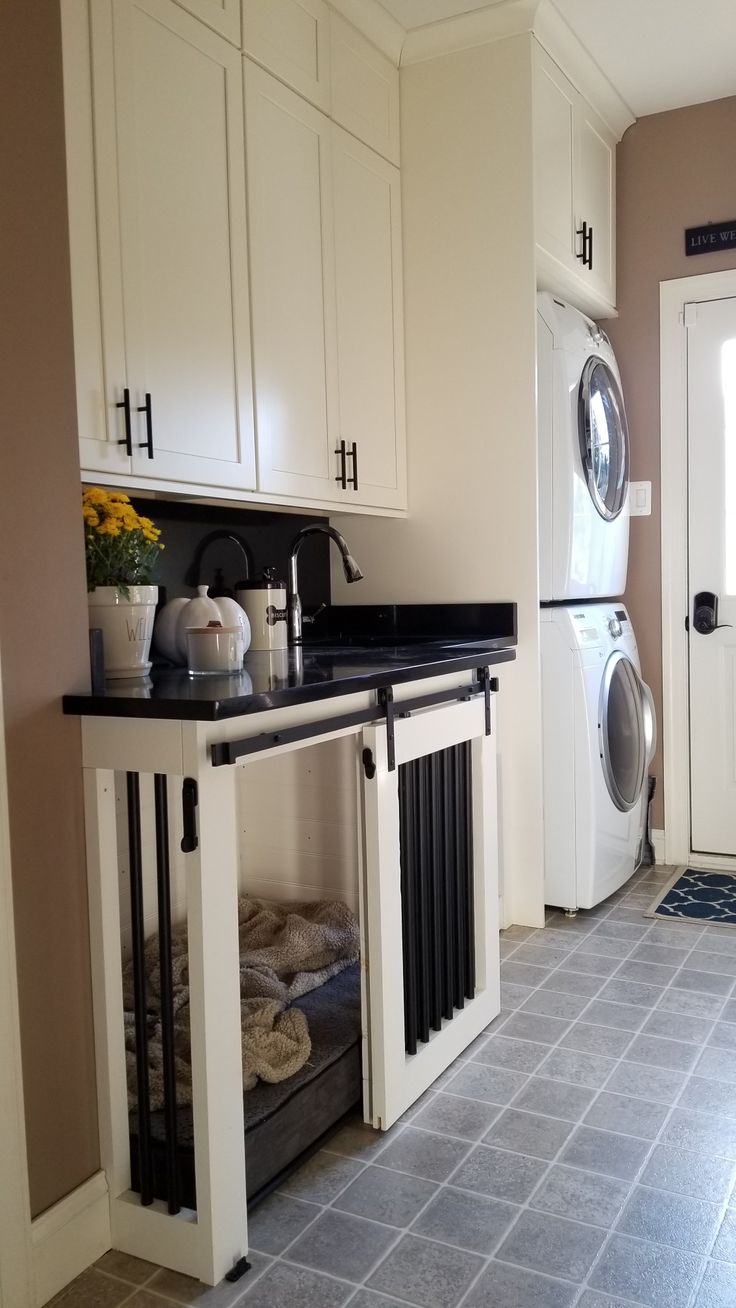 a washer and dryer in a room with tile flooring on the floor