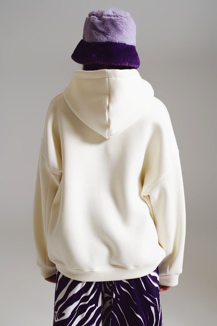 Experience unparalleled comfort and style with our Iconic Oversized Hoodie in White. Made with a plush blend of 80% cotton and 20% polyester, this hoodie promises a soft touch against the skin. The bold "ICONIC" text emblazoned on the front transforms this basic hoodie into a statement piece. Its oversized design provides a relaxed, comfy fit, perfect for those laid-back days. The model, standing at 5'9" with measurements 32-25-36, is wearing a size U. As the hoodie runs big, we recommend sizing Oversized Cream Sweatshirt Trendy Style, Oversized Cream Sweatshirt, Trendy Style, Trendy Oversized Cream Sweatshirt, Super Soft Fleece Hoodie With Relaxed Fit, Super Soft Fleece Hoodie In Relaxed Fit, Oversized White Outerwear With Drawstring Hood, Oversized Cream Cotton Hoodie, Oversized White Sweatshirt With Kangaroo Pocket, White Oversized Sweatshirt With Double-lined Hood