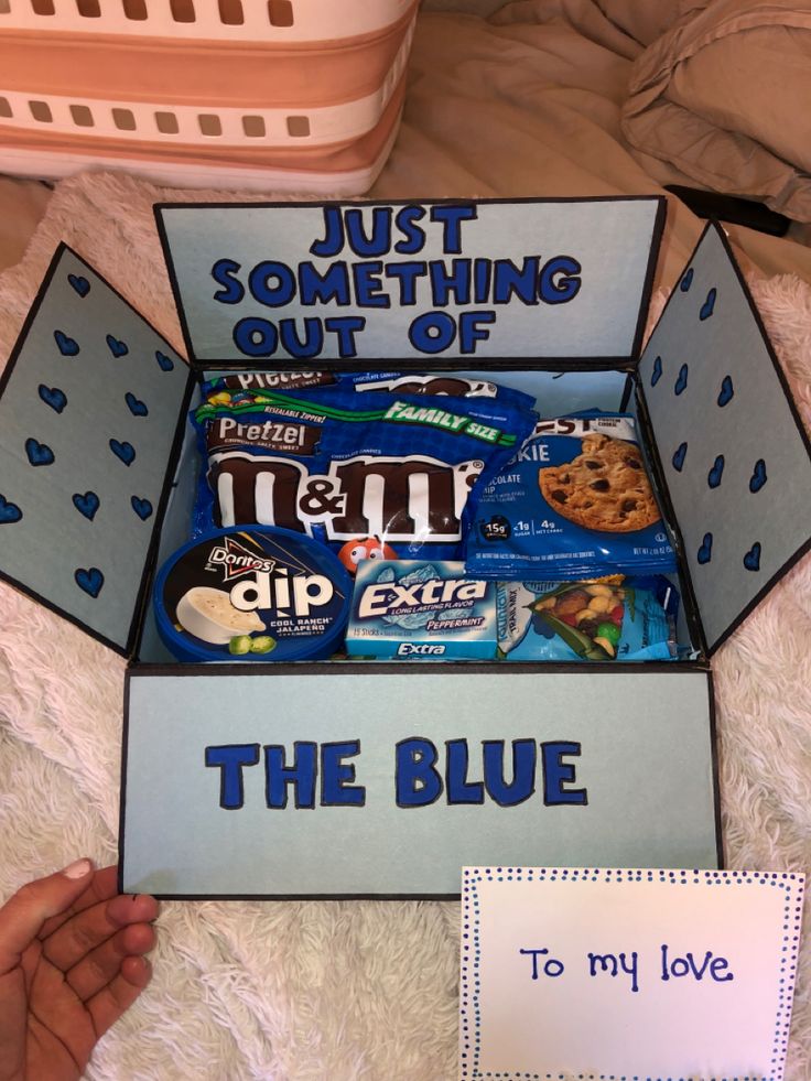 the blue box is filled with cookies and candy