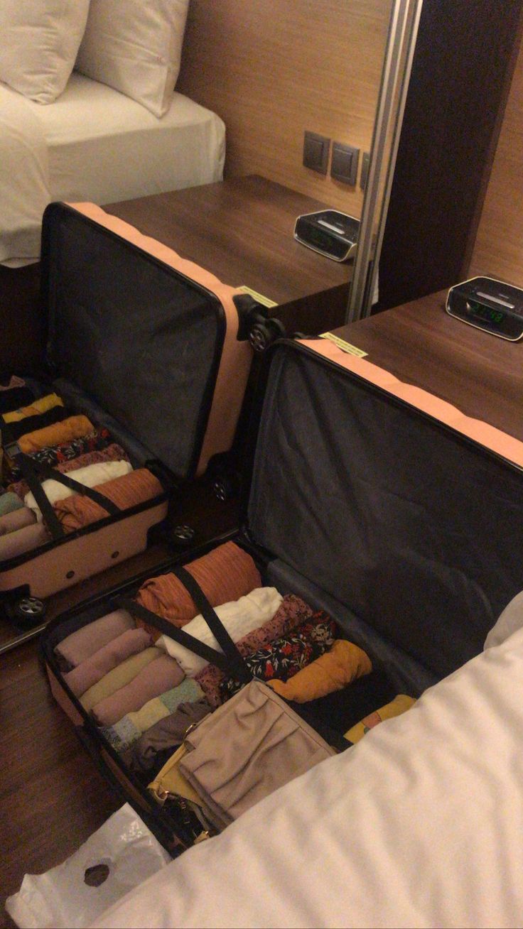 an open suitcase sitting on top of a bed