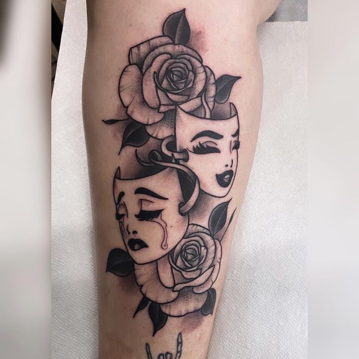 a woman's face with roses and the word love tattooed on her leg in black ink