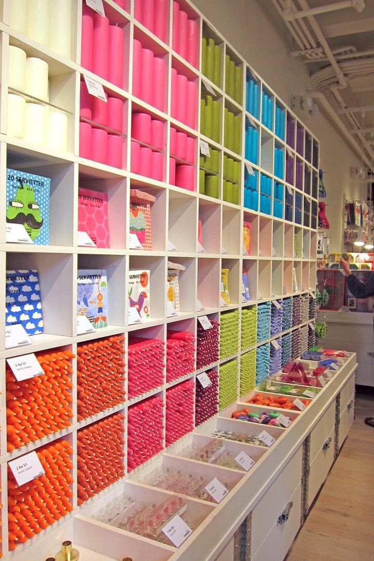 the shelves are filled with lots of different colored boxes and bins for crafting